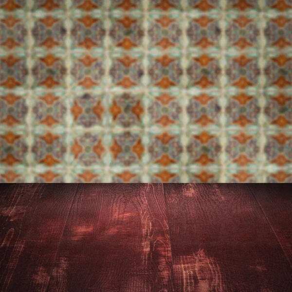 Wood table top and blur vintage ceramic tile pattern wall — Stock Photo, Image