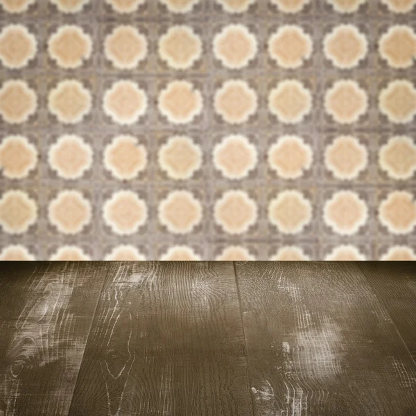 Wood table top and blur vintage ceramic tile pattern wall — Stock Photo, Image