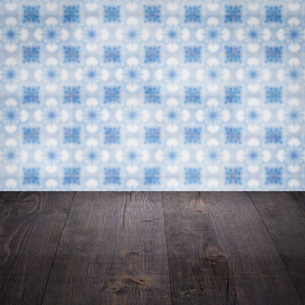 Wood table top and blur vintage ceramic tile pattern wall — Stock Photo, Image