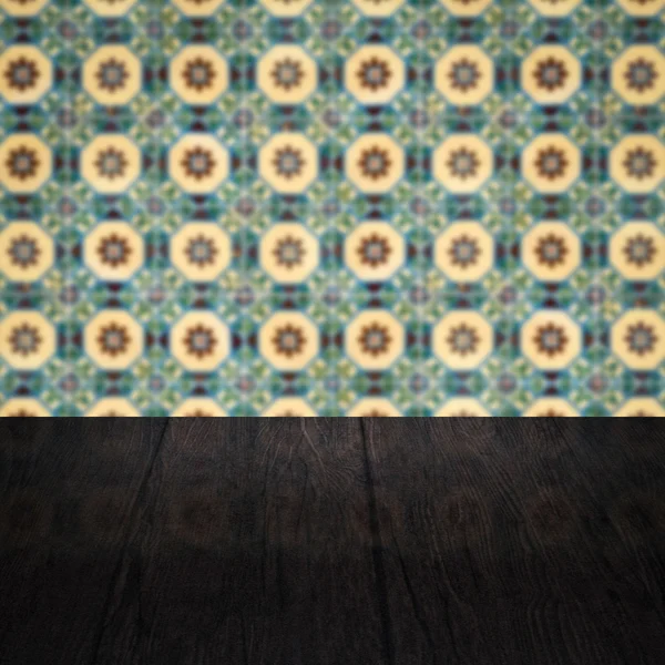 Wood table top and blur vintage ceramic tile pattern wall — Stock Photo, Image