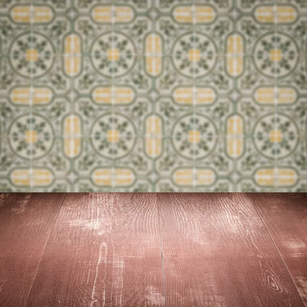 Wood table top and blur vintage ceramic tile pattern wall — Stock Photo, Image