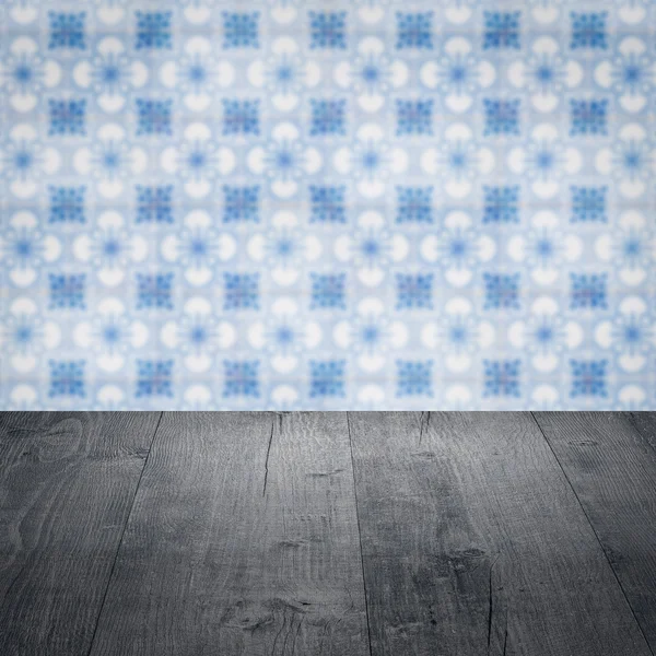 Wood table top and blur vintage ceramic tile pattern wall — Stock Photo, Image