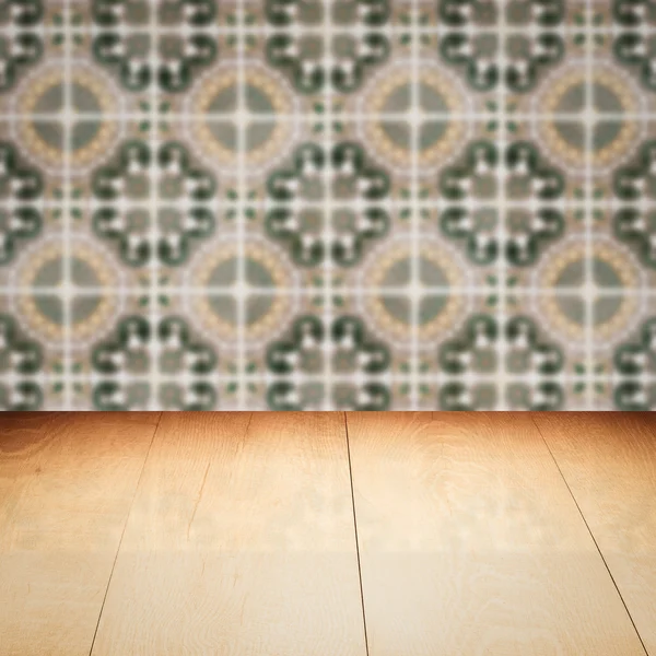 Wood table top and blur vintage ceramic tile pattern wall — Stock Photo, Image