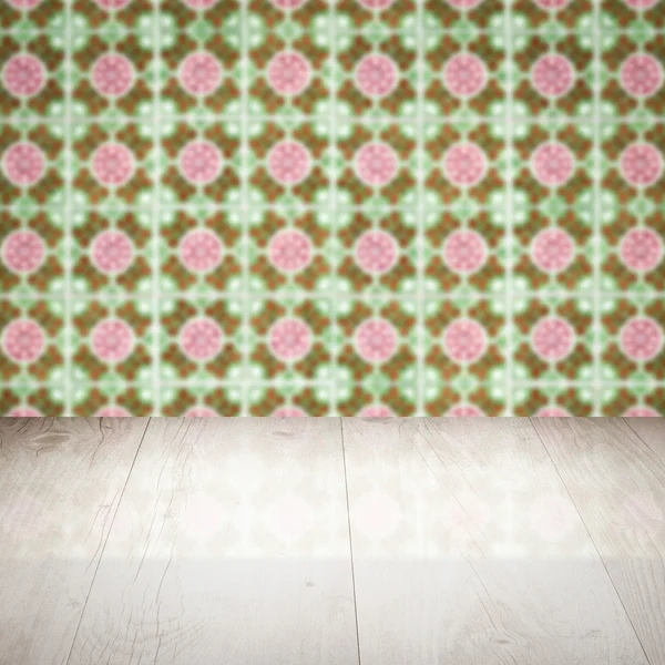 Wood table top and blur vintage ceramic tile pattern wall — Stock Photo, Image