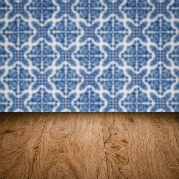 Wood table top and blur vintage ceramic tile pattern wall — Stock Photo, Image