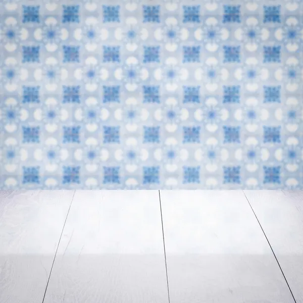 Wood table top and blur vintage ceramic tile pattern wall — Stock Photo, Image