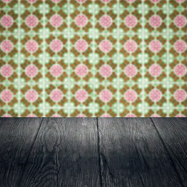 Wood table top and blur vintage ceramic tile pattern wall — Stock Photo, Image