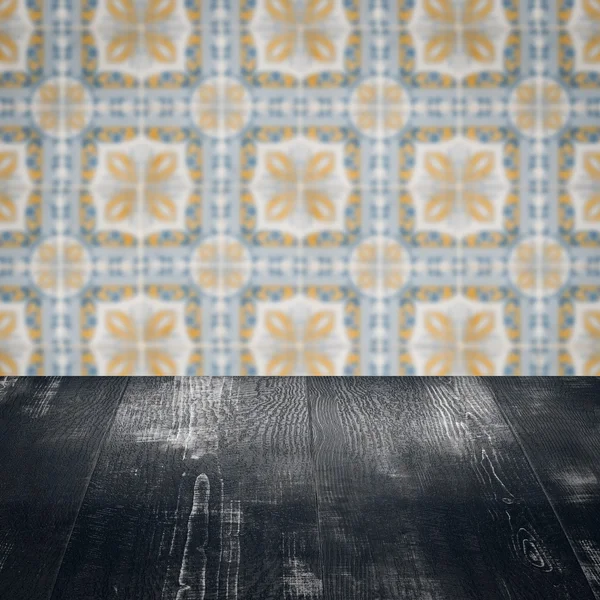 Wood table top and blur vintage ceramic tile pattern wall — Stock Photo, Image