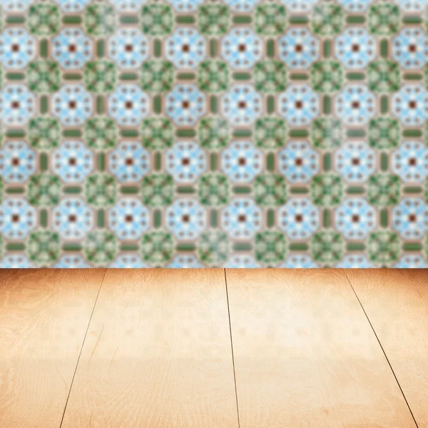 Wood table top and blur vintage ceramic tile pattern wall — Stock Photo, Image