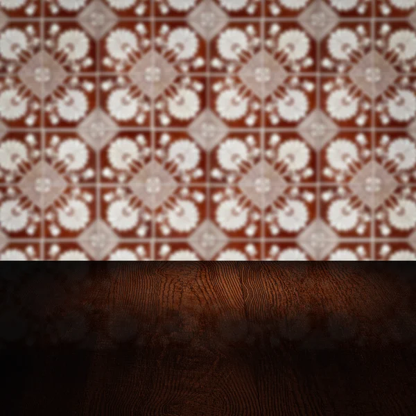 Wood table top and blur vintage ceramic tile pattern wall Royalty Free Stock Images