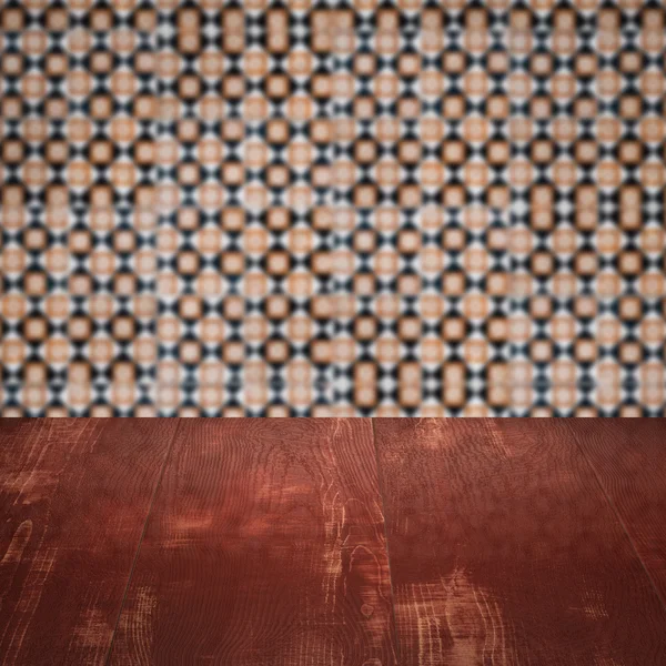 Wood table top and blur vintage ceramic tile pattern wall — Stock Photo, Image