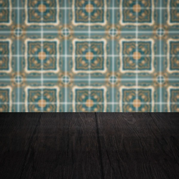 Wood table top and blur vintage ceramic tile pattern wall — Stock Photo, Image