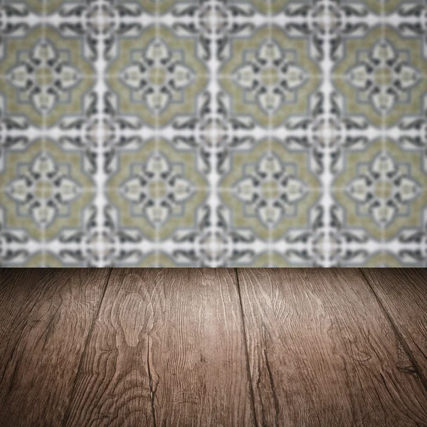 Wood table top and blur vintage ceramic tile pattern wall — Stock Photo, Image