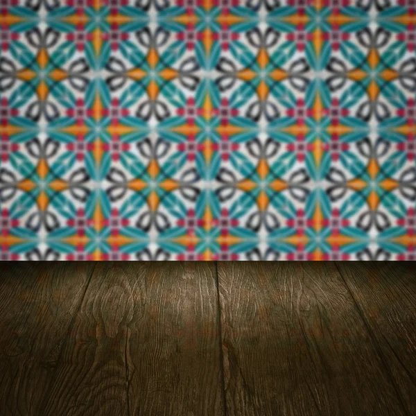 Wood table top and blur vintage ceramic tile pattern wall — Stock Photo, Image