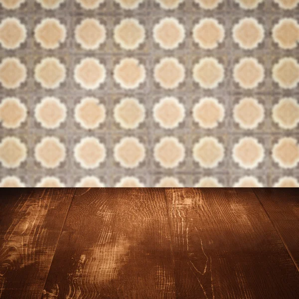 Wood table top and blur vintage ceramic tile pattern wall — Stock Photo, Image