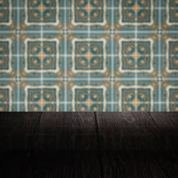 Wood table top and blur vintage ceramic tile pattern wall — Stock Photo, Image