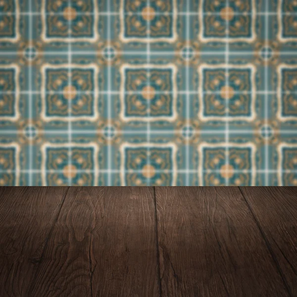 Wood table top and blur vintage ceramic tile pattern wall — Stock Photo, Image