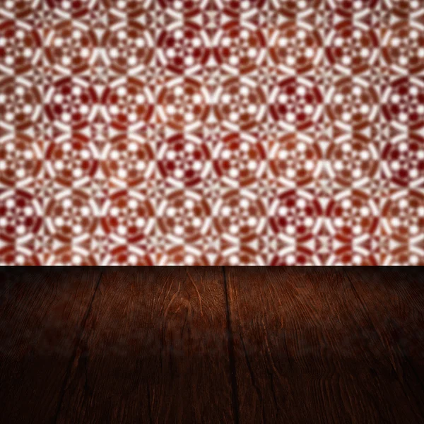 Wood table top and blur vintage ceramic tile pattern wall — Stock Photo, Image