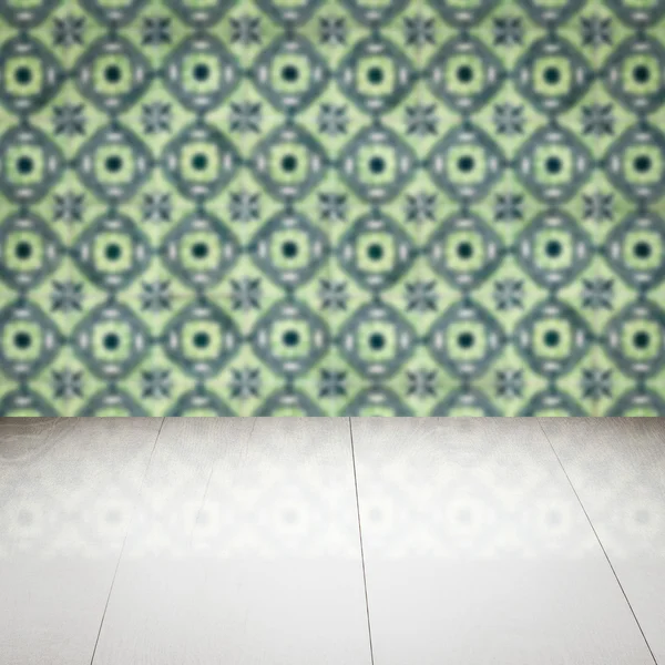 Wood table top and blur vintage ceramic tile pattern wall — Stock Photo, Image