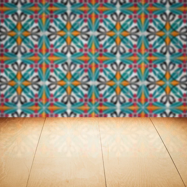 Wood table top and blur vintage ceramic tile pattern wall — Stock Photo, Image