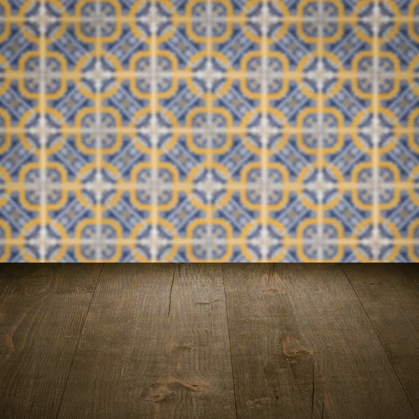 Wood table top and blur vintage ceramic tile pattern wall — Stock Photo, Image