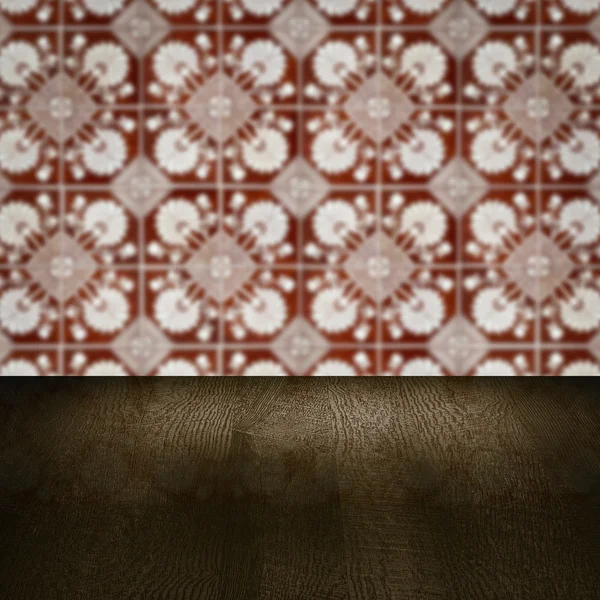 Wood table top and blur vintage ceramic tile pattern wall Royalty Free Stock Photos