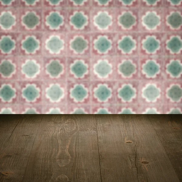 Wood table top and blur vintage ceramic tile pattern wall — Stock Photo, Image