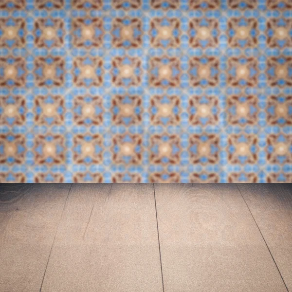 Wood table top and blur vintage ceramic tile pattern wall — Stock Photo, Image