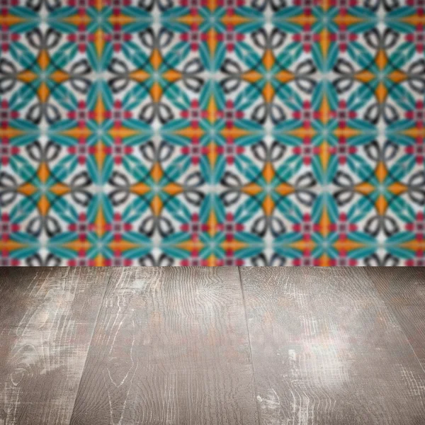 Wood table top and blur vintage ceramic tile pattern wall — Stock Photo, Image