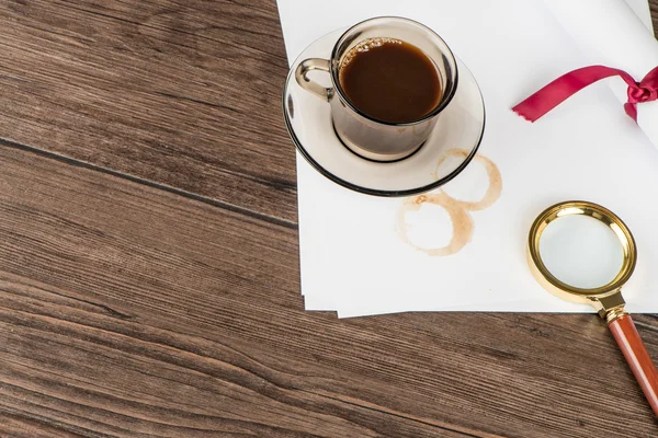 Coffee cup, paper sheets and detective hat — Stock Photo, Image