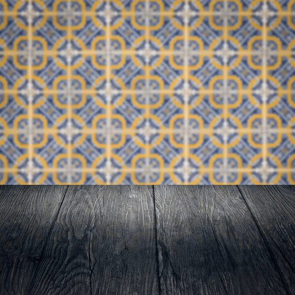 Wood table top and blur vintage ceramic tile pattern wall — Stock Photo, Image