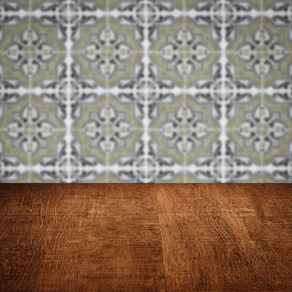 Wood table top and blur vintage ceramic tile pattern wall — Stock Photo, Image