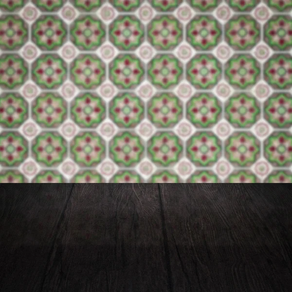 Wood table top and blur vintage ceramic tile pattern wall — Stock Photo, Image