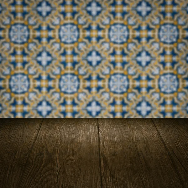 Wood table top and blur vintage ceramic tile pattern wall — Stock Photo, Image