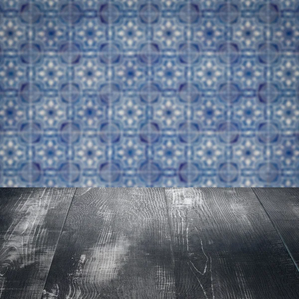 Wood table top and blur vintage ceramic tile pattern wall — Stock Photo, Image