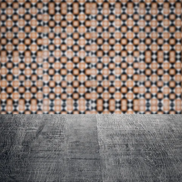 Wood table top and blur vintage ceramic tile pattern wall — Stock Photo, Image