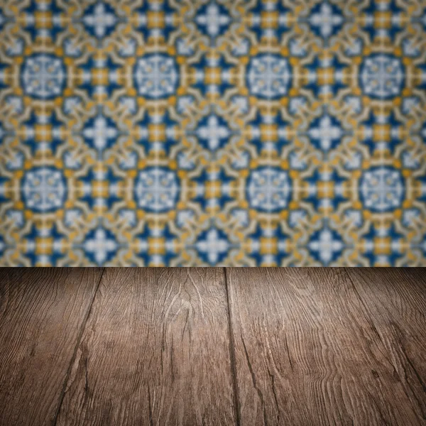 Wood table top and blur vintage ceramic tile pattern wall — Stock Photo, Image