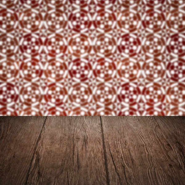 Wood table top and blur vintage ceramic tile pattern wall — Stock Photo, Image