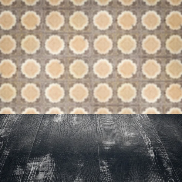 Wood table top and blur vintage ceramic tile pattern wall — Stock Photo, Image