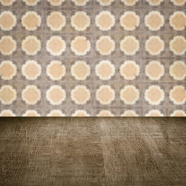 Wood table top and blur vintage ceramic tile pattern wall — Stock Photo, Image