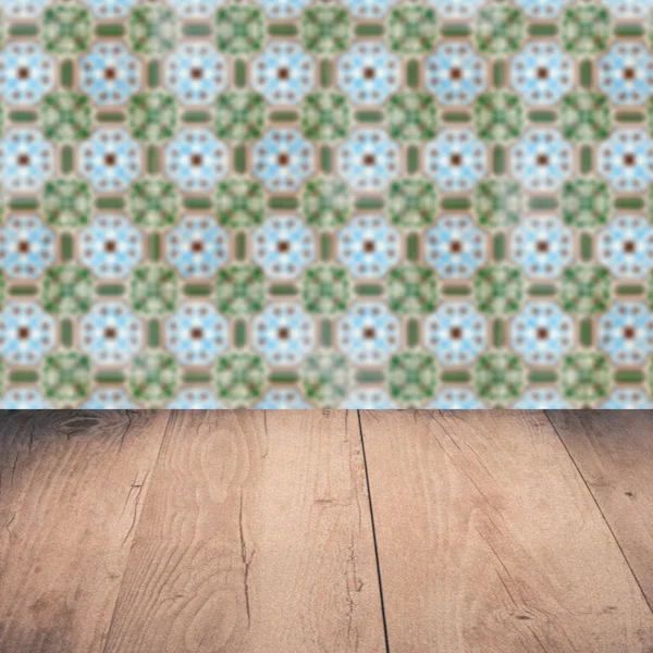 Wood table top and blur vintage ceramic tile pattern wall — Stock Photo, Image