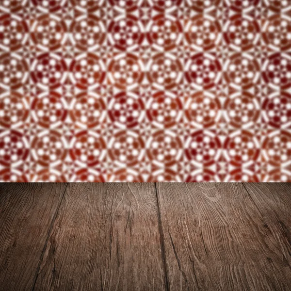 Wood table top and blur vintage ceramic tile pattern wall — Stock Photo, Image