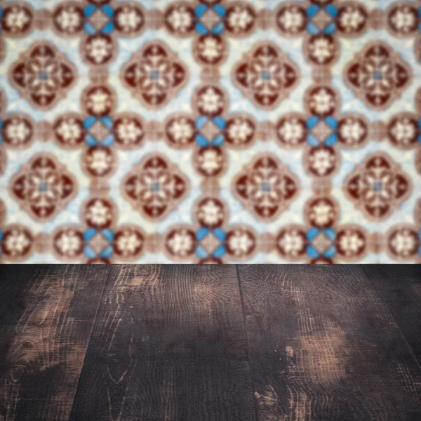 Wood table top and blur vintage ceramic tile pattern wall — Stock Photo, Image