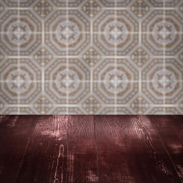 Wood table top and blur vintage ceramic tile pattern wall — Stock Photo, Image