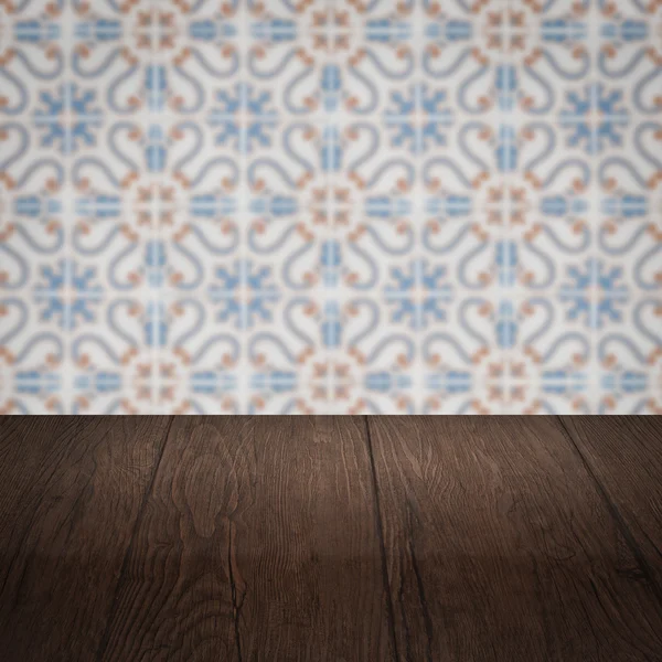 Wood table top and blur vintage ceramic tile pattern wall — Stock Photo, Image