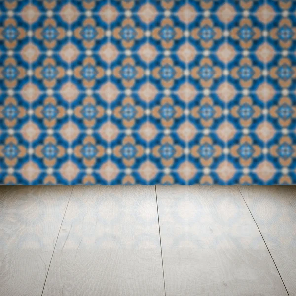 Wood table top and blur vintage ceramic tile pattern wall — Stock Photo, Image