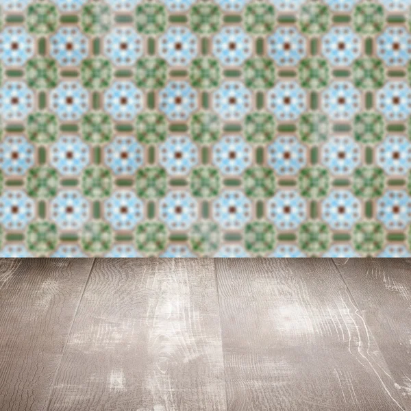 Wood table top and blur vintage ceramic tile pattern wall — Stock Photo, Image