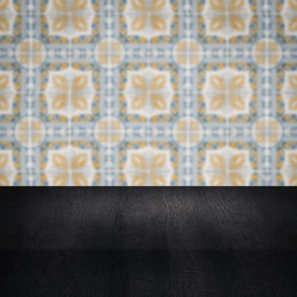 Wood table top and blur vintage ceramic tile pattern wall — Stock Photo, Image