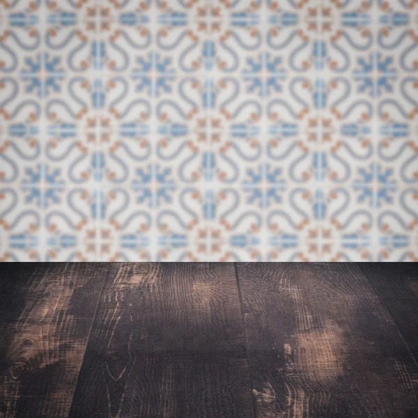 Wood table top and blur vintage ceramic tile pattern wall — Stock Photo, Image