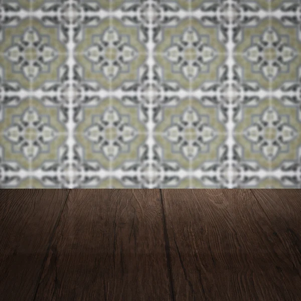 Wood table top and blur vintage ceramic tile pattern wall — Stock Photo, Image